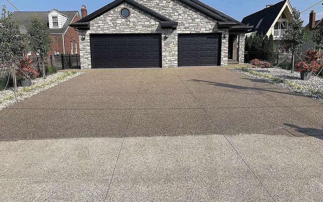 Exposed aggregate concrete driveway in front of a central Indiana home