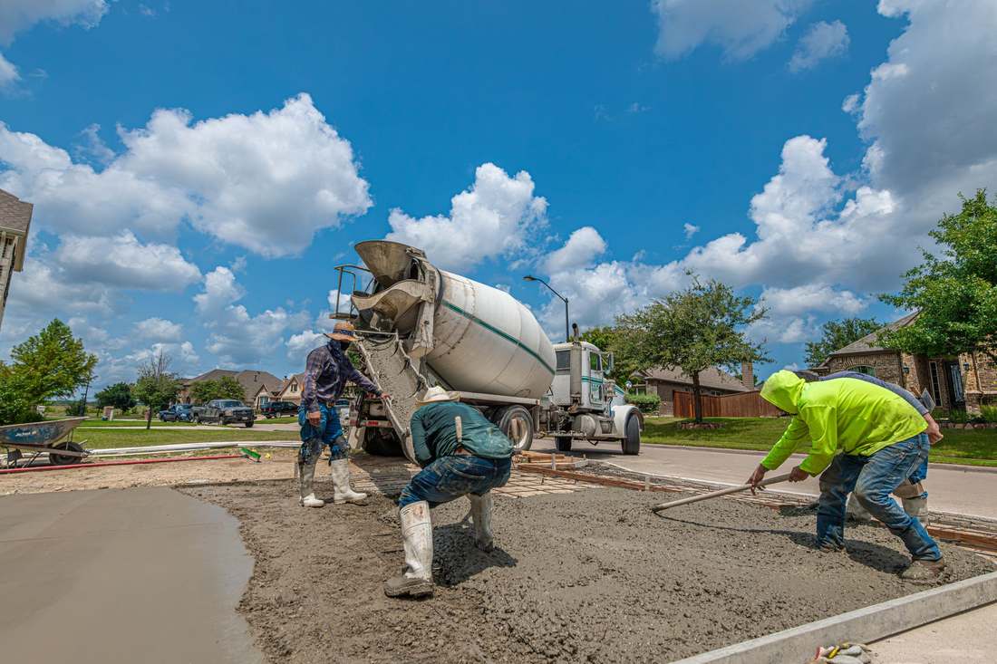 Crew placing concrete for a residential driveway