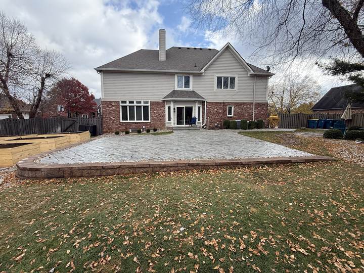 Large rear patio at a brick and stone home in Carmel, Indiana