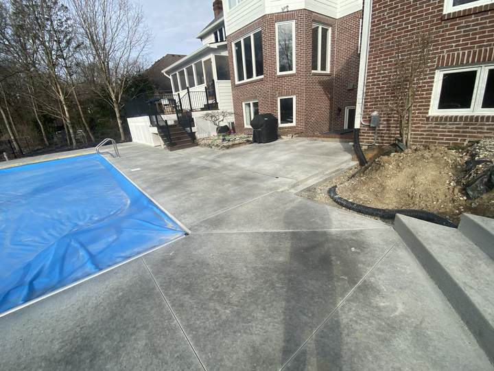 Concrete deck around a covered pool in Carmel, Indiana