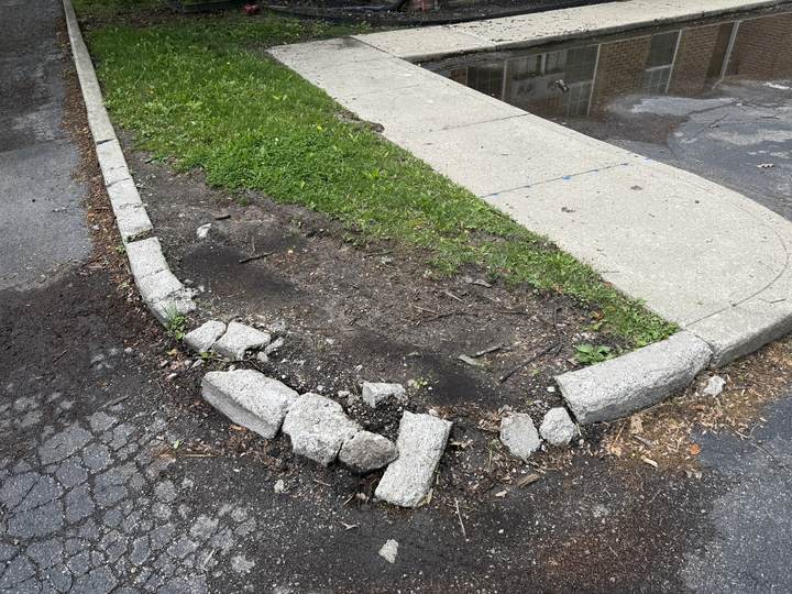 Broken and displaced walk and curb before replacement in Carmel, Indiana