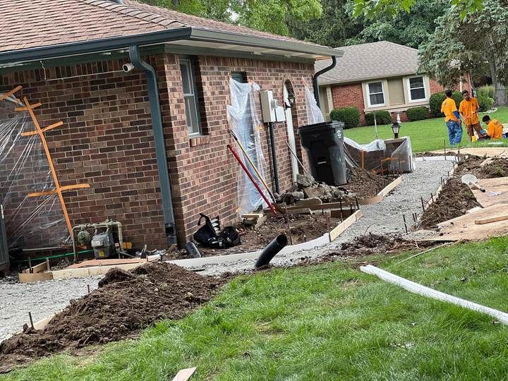 Crew working at a brick home