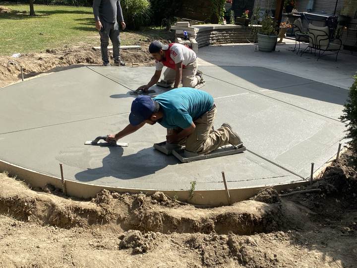 Crew hand finishing a curved patio