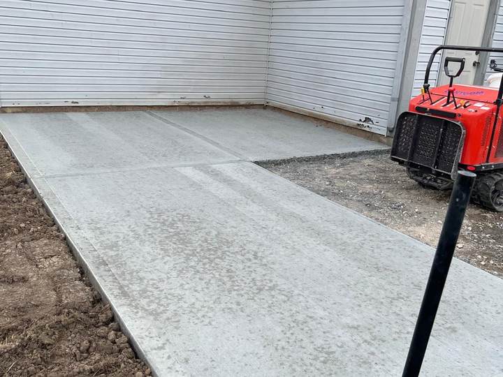 Slab with a plate compactor on site