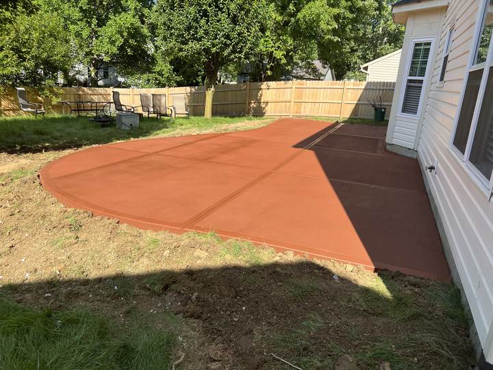 Terracotta colored patio beside a house