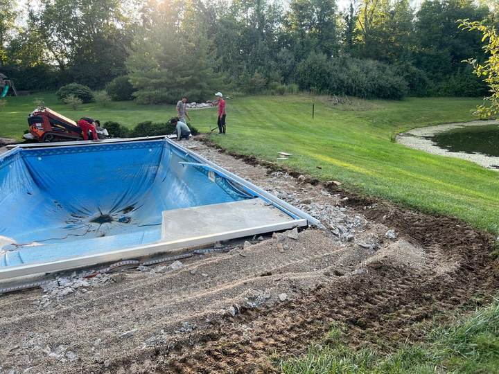 Concrete deck being formed around a pool