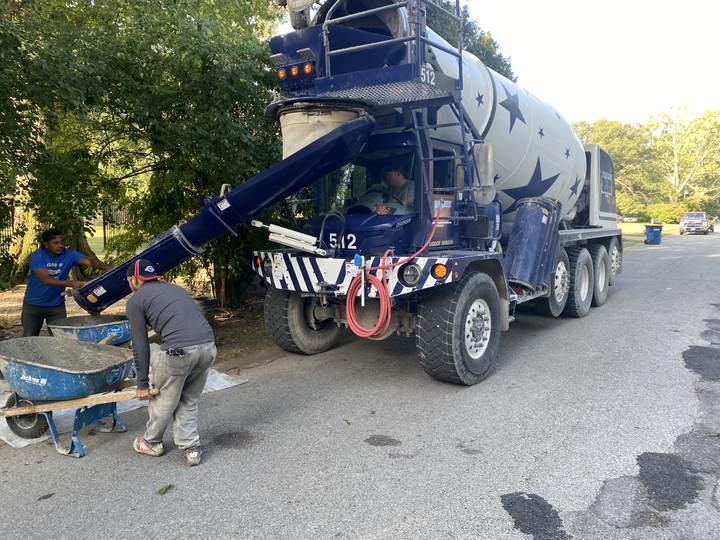 Concrete pump truck and crew on a residential street in Indianapolis, Indiana