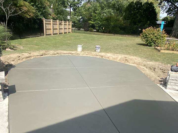 Fresh broom finish patio, curved edge, fenced yard in Indianapolis, Indiana