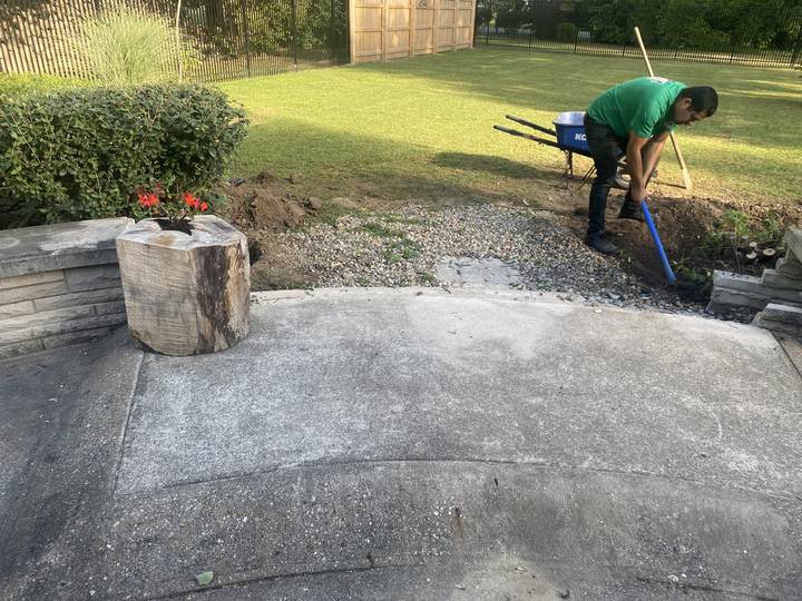 Crew member working, existing patio and fire pit in Indianapolis, Indiana