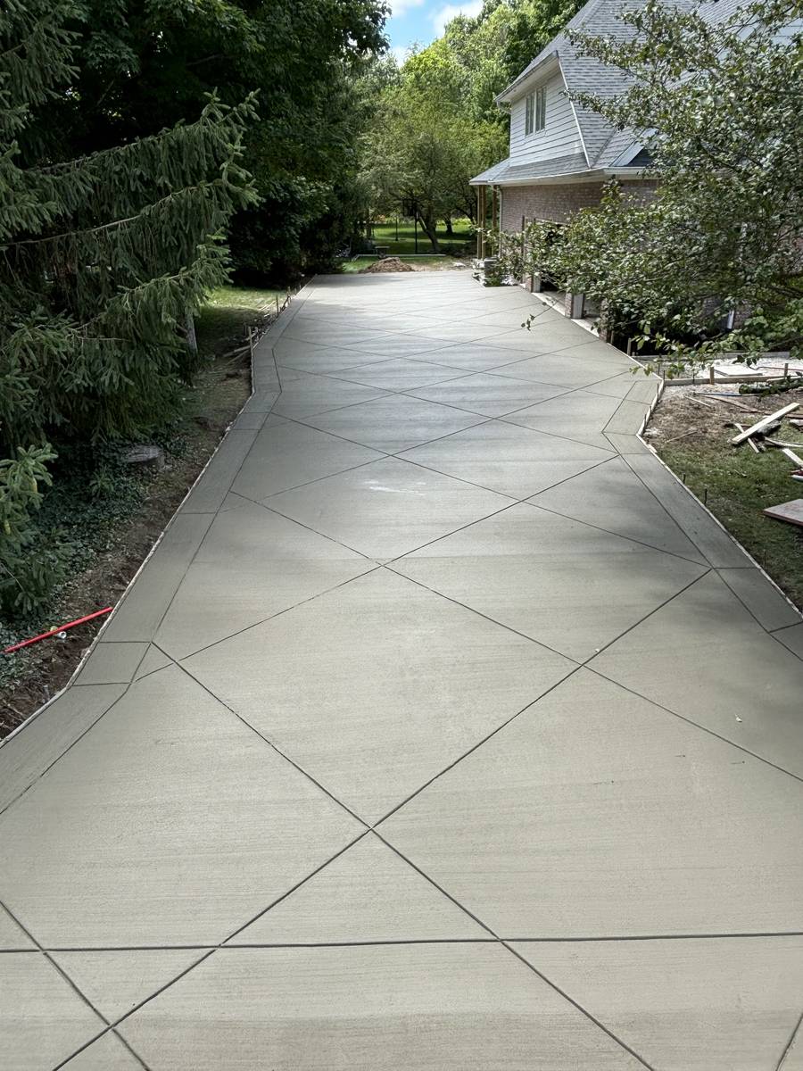 Crew placing concrete for a residential driveway